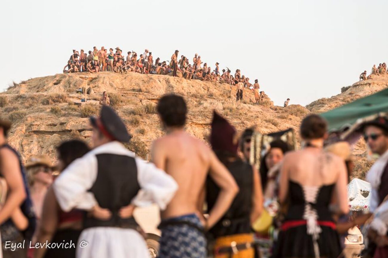 A joyful pile of participants together in the dust